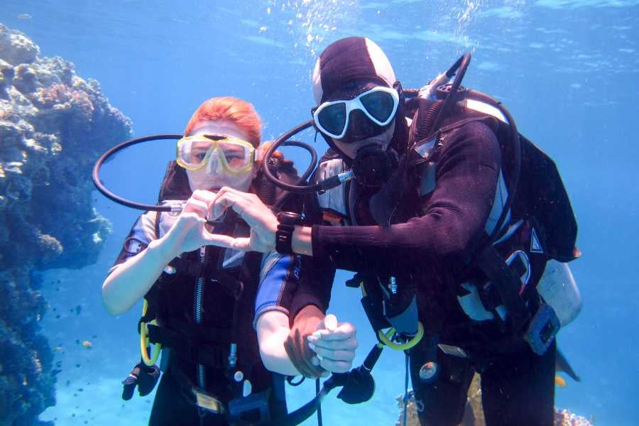 Two diver are enjoying a deep water diving adventure 