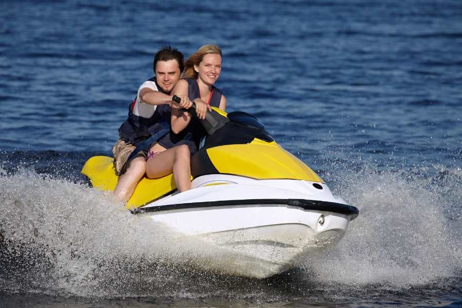 A couple enjoying a thrilling jet skiing experience