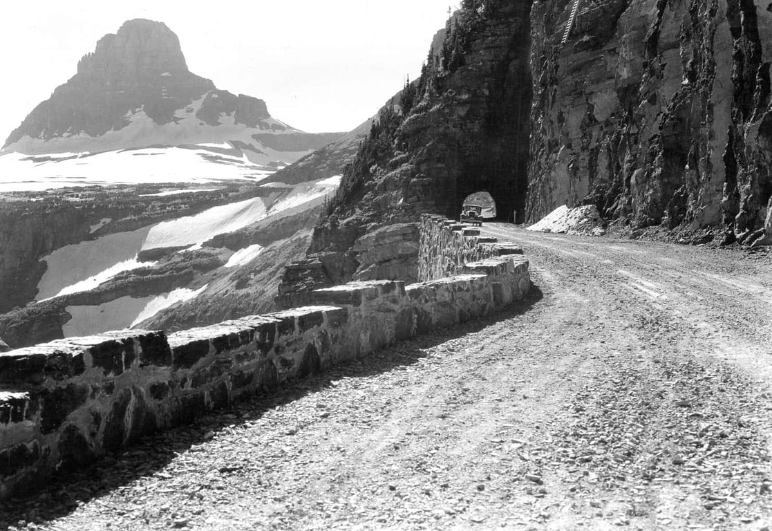 a historic black and white photo of an unpaved going-to-the-sun road