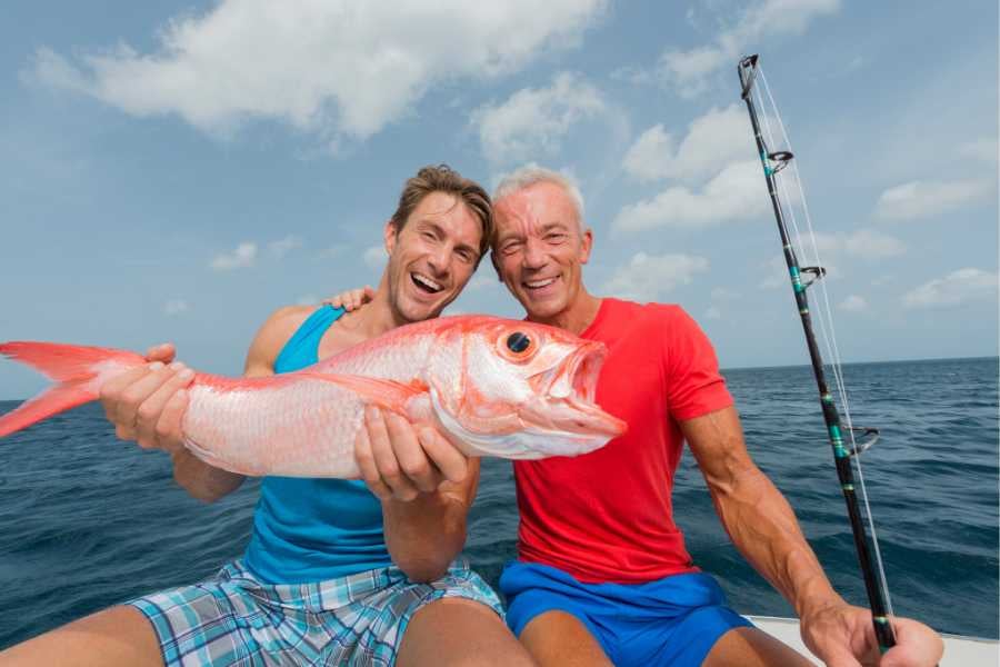 Two men are enjoying catching fish