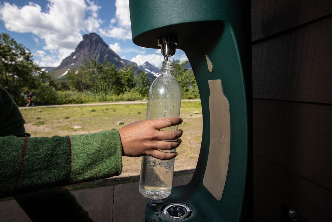 person filling their water bottle