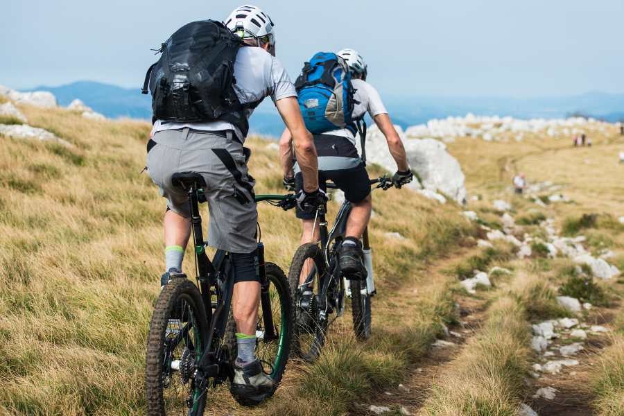 Two cyclists exploring a rugged mountain trail, embracing adventure and breathtaking landscapes.