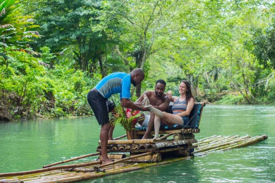 A guide gives a foot massage on a scenic bamboo raft.