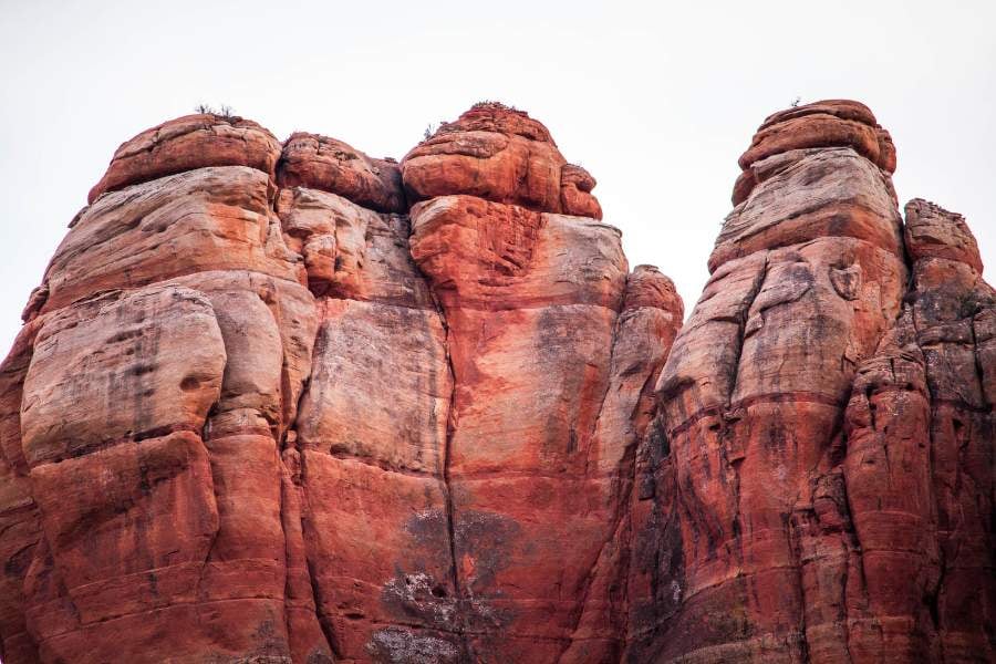 Tall red rock cliffs rise high, shaped by wind and time.