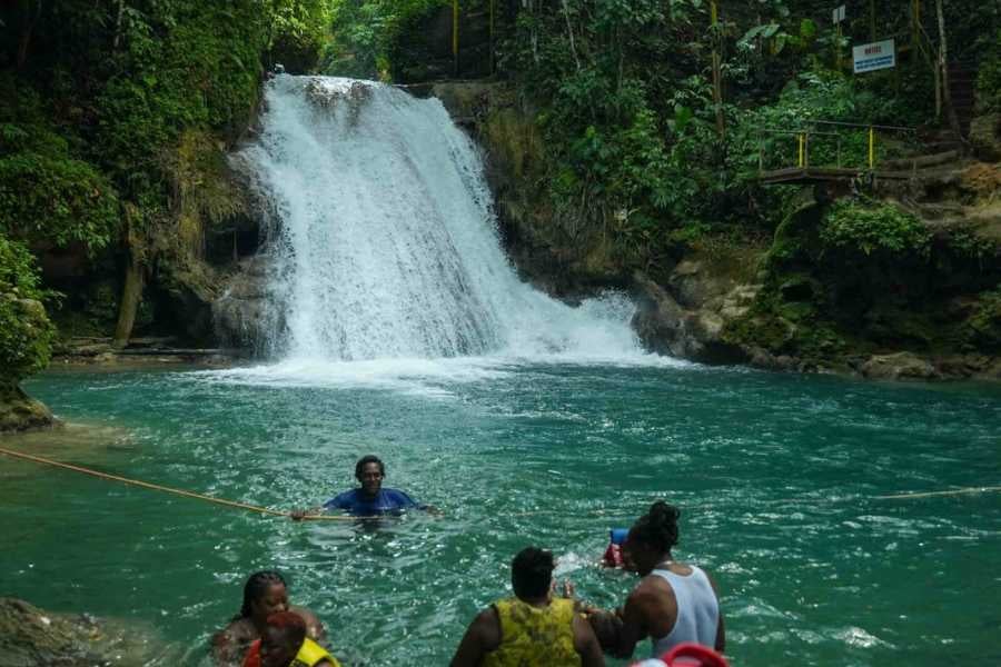 A serene waterfall plunging into a refreshing turquoise pool, perfect for a swim in nature’s paradise.