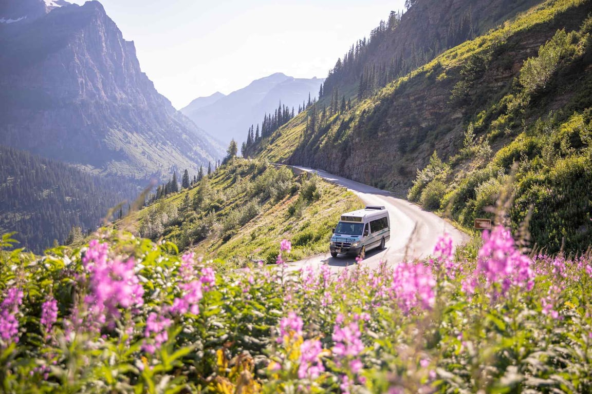 A shuttle van driving along Going-to-the-Sun Road