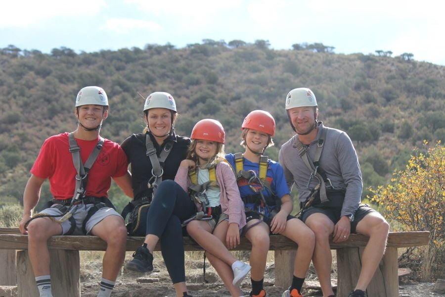 A family smiles after a fun zipline adventure near Breckenridge.
