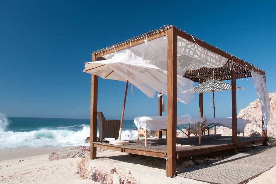 A breezy cabana with ocean views, perfect for a relaxing beachside massage or unwinding in luxury.