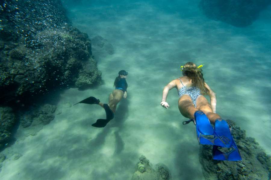 Two girls are enjoying diving in deep water