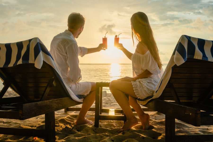 A couple enjoying the evening view on the beach