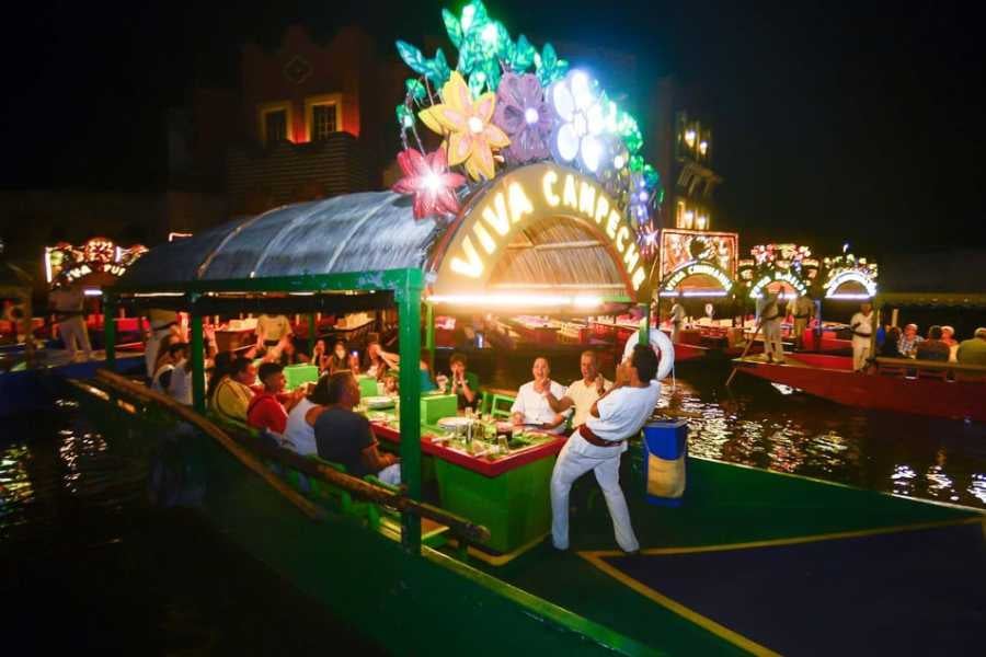 A festive night filled with dancing and dining on creatively decorated boats glowing under bright lights.