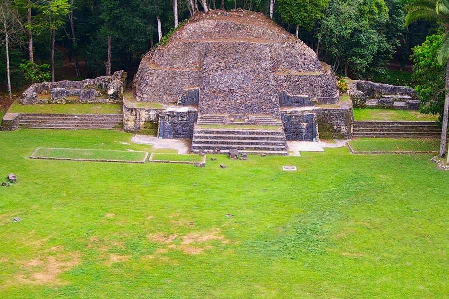 Ancient Mayan ruin surrounded by lush greenery, showcasing timeless history and stunning architecture.