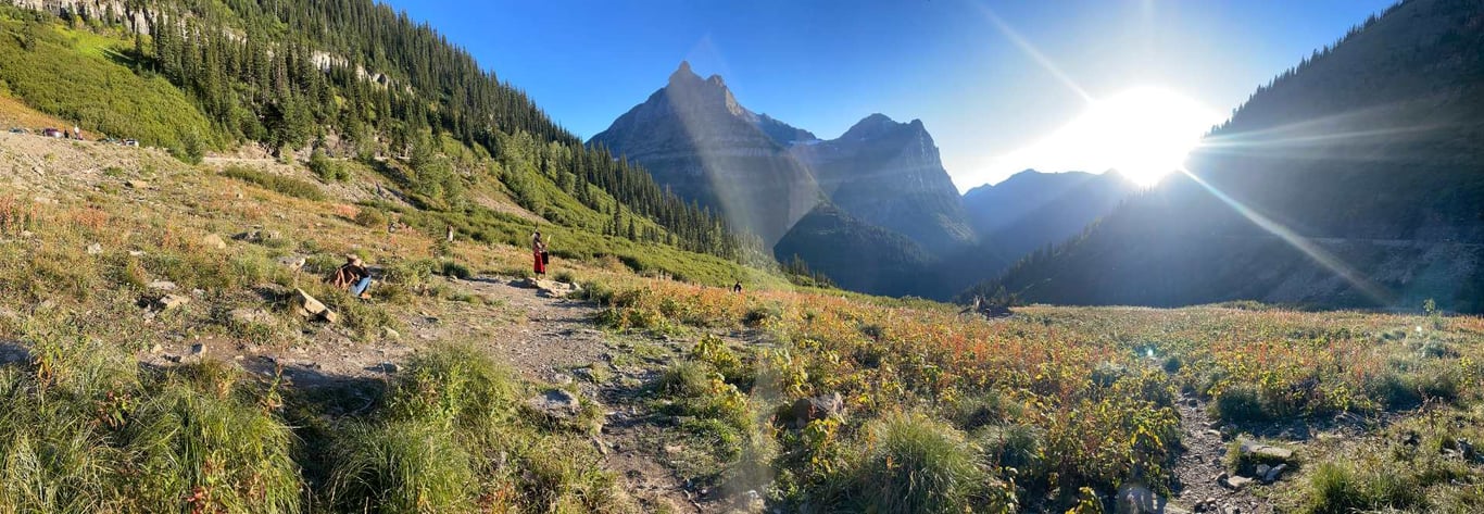 woman taking photos at sunset in glacier park