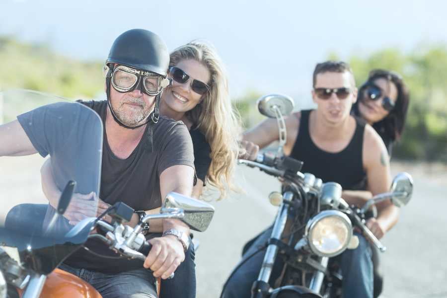 Two couples are going for a motorcycle ride