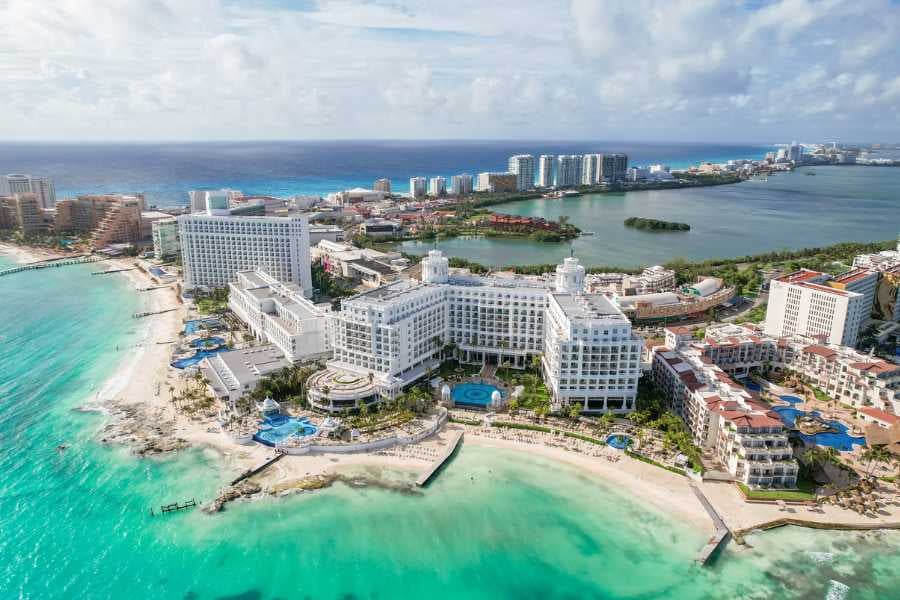 A stunning aerial view of Cancun's sparkling turquoise waters and luxury resorts along the beach.