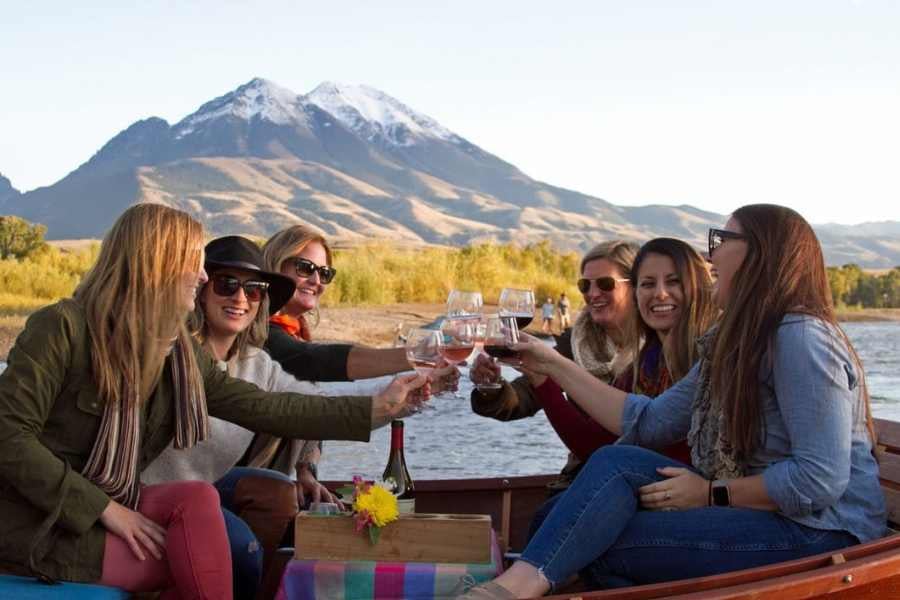 A group of friends enjoying a celebratory toast against a mountain backdrop.