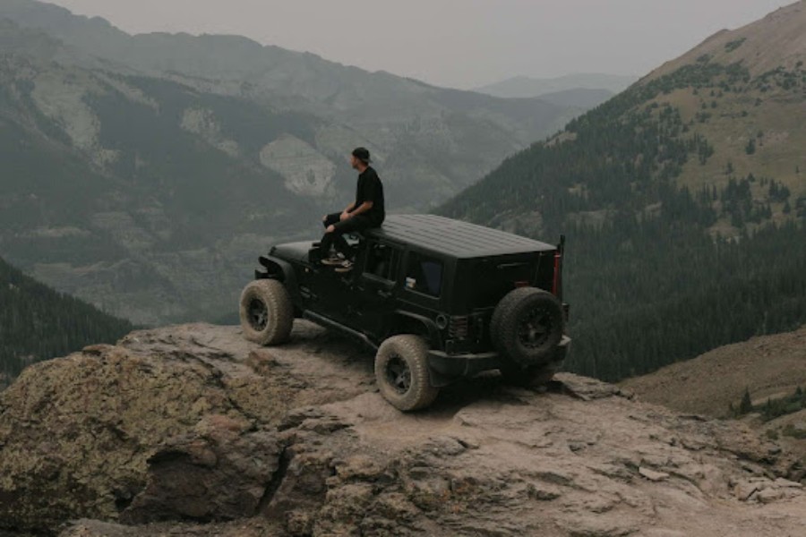 A man is enjoying himself on the top of a mountain