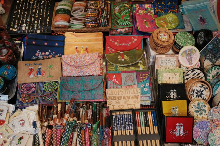 A market table filled with colorful handmade crafts and souvenirs.