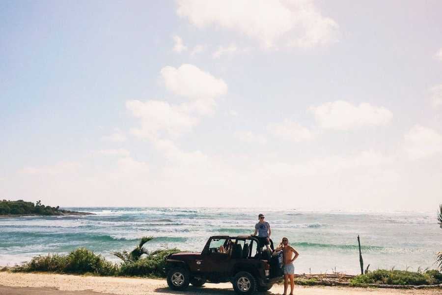 A couple stops by the ocean in their Jeep, soaking in the sea breeze and endless horizon views.