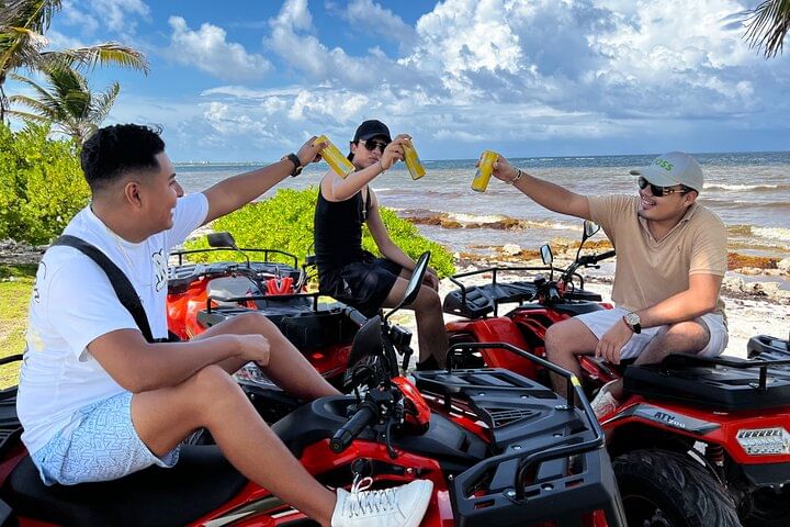ATV tour riders on the coast near Costa Maya with Caribbean water in the background