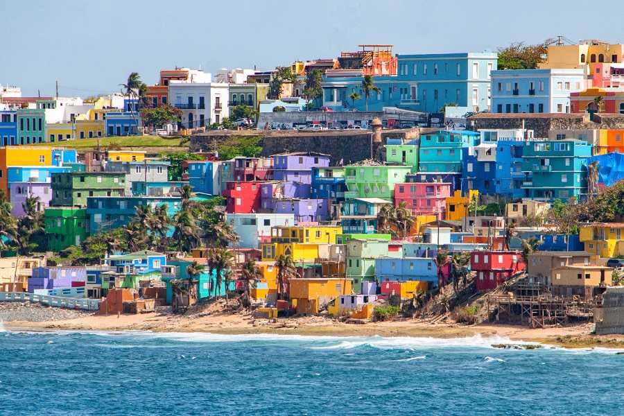 A vibrant hillside of colorful houses overlooking the sea, blending culture and coastal charm.