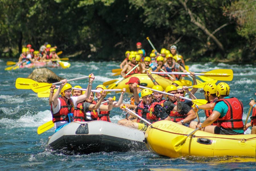 Dozens of rafts race downriver in an action-packed whitewater adventure.