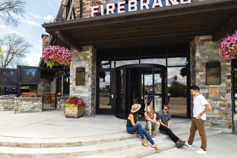 A group relaxes outside Firebrand, enjoying the sunny day.