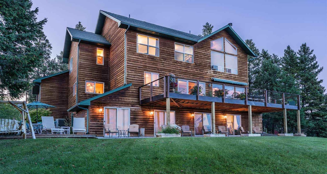 brown lodge on hill with windows illuminated