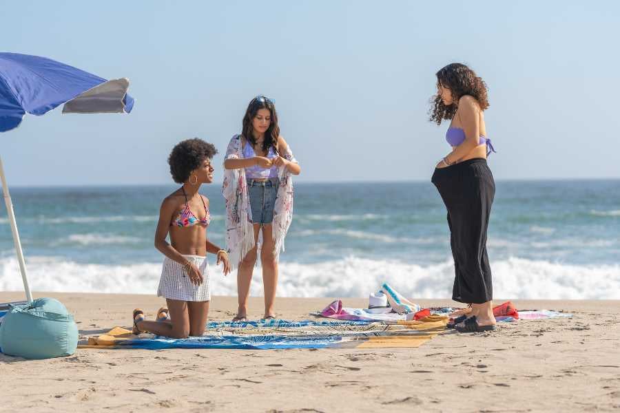 Three women are relaxing on the beach