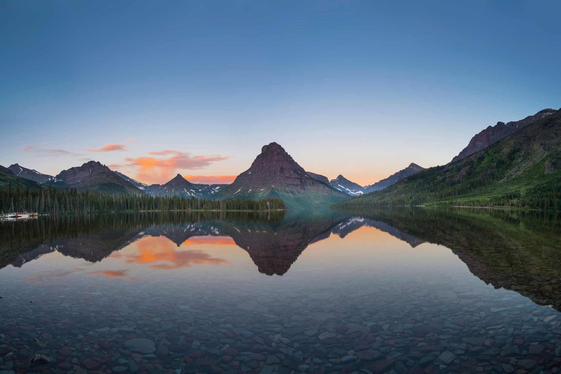 reflection of glacier park mountain in two medicine lake