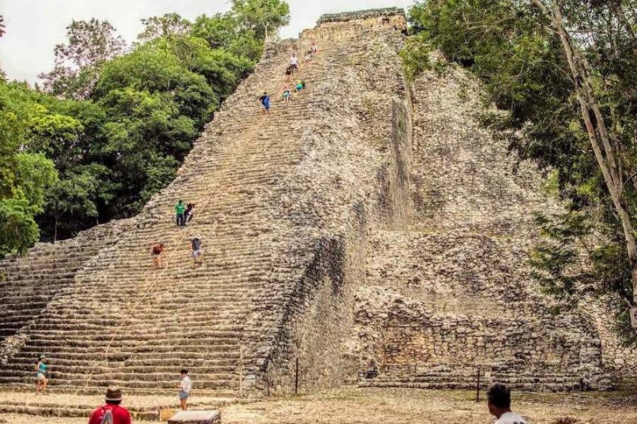 A towering Mayan temple with intricate stonework invites adventurers to explore its rich history.