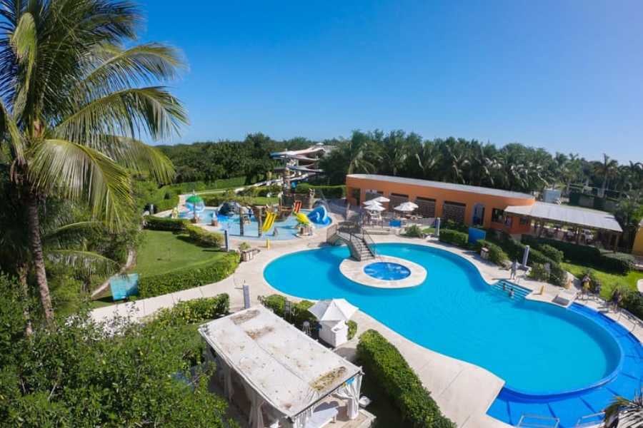 A tropical resort with lush greenery, refreshing pools, and exciting waterslides for all ages.