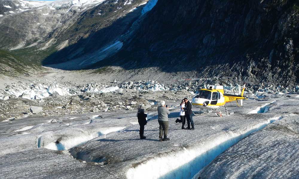 Visitors standing on Herbert Glacier during a helicopter glacier landing excursion in Juneau