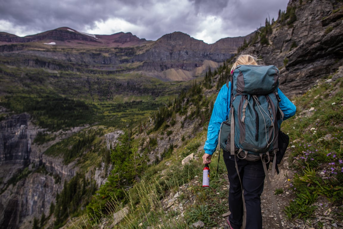 A hiker carrying bear spray