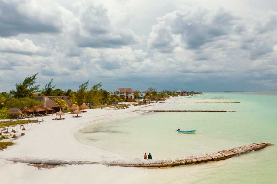 A tranquil beach with white sand and turquoise water.