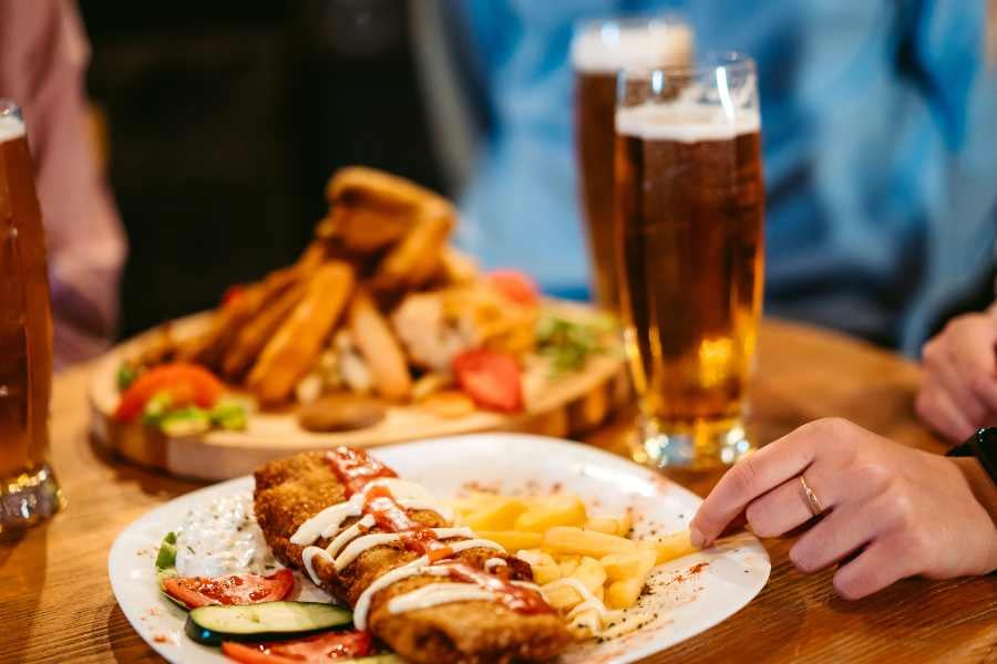 Crispy fried dish with fries and cold beer.