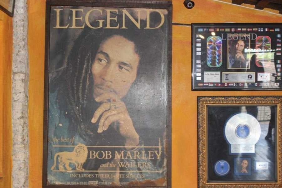 A worn yet iconic Bob Marley poster, celebrating his legendary music and everlasting influence on reggae culture.