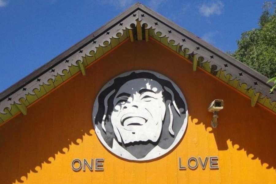 A bright mural of Bob Marley with the words "One Love" radiates Jamaican culture and vibrant energy.