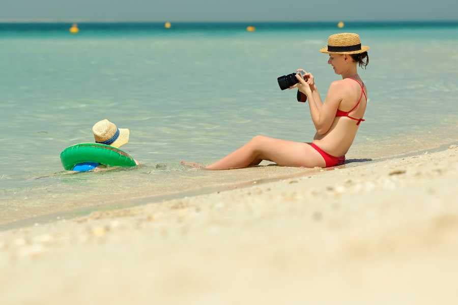 A woman taking a picture of her child