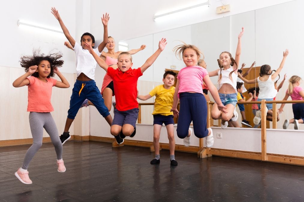 A group of children jump with energy during a Breckenridge dance class.