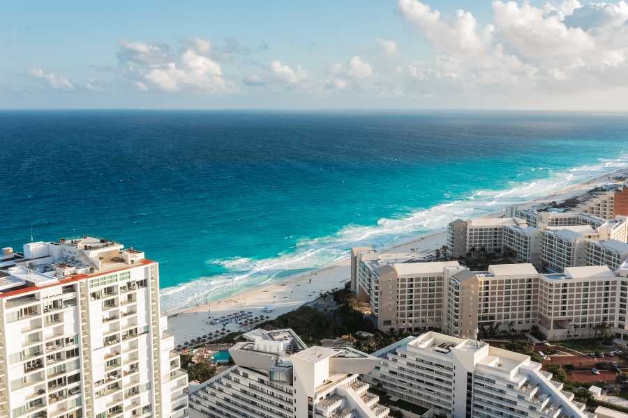 Towering beachfront resorts overlooking the Caribbean’s shimmering blue waves in Cancun.