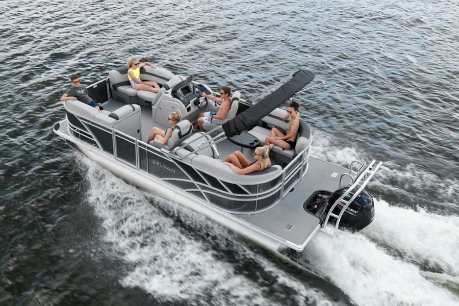 Group relaxes on a pontoon boat cruising smoothly across the water.