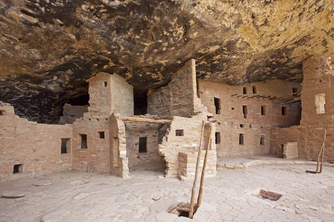 ladder extending from hole in Pueblan home in Mesa Verde