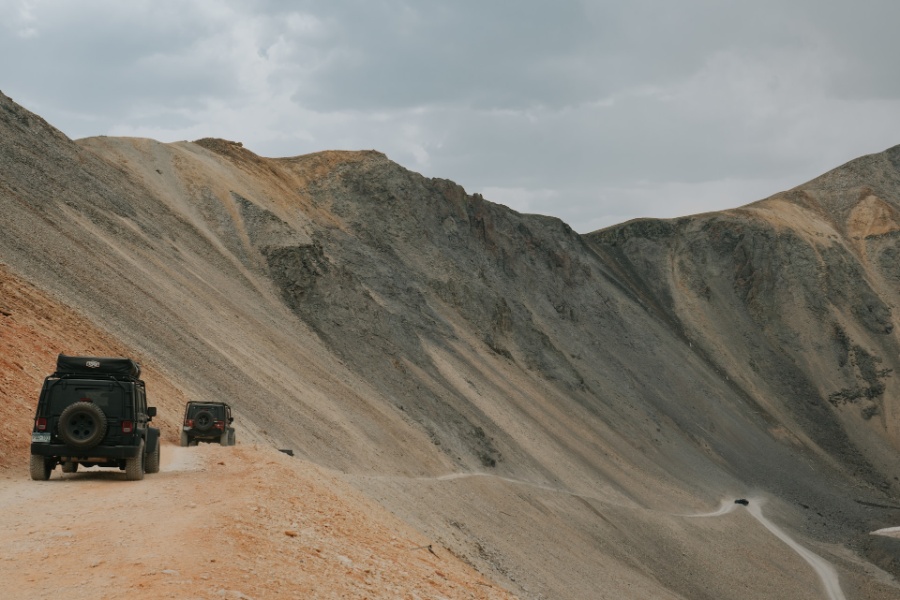 Jeeps are going in roads between mountains