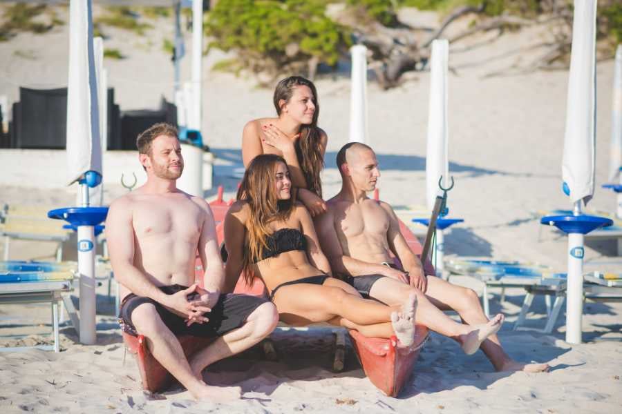 Some friends are sitting on the beach having fun