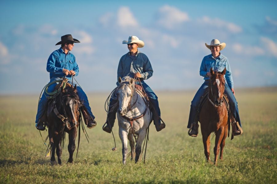 Three riders talk and ride across Breckenridge&rsquo;s wide open fields.