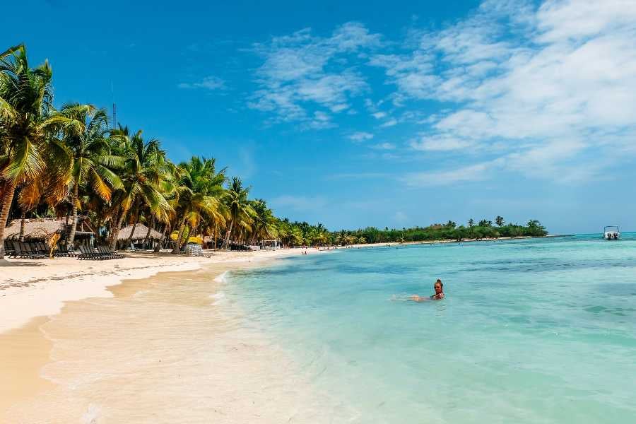 A swimmer enjoying the crystal-clear water at a beautiful, serene tropical beach.