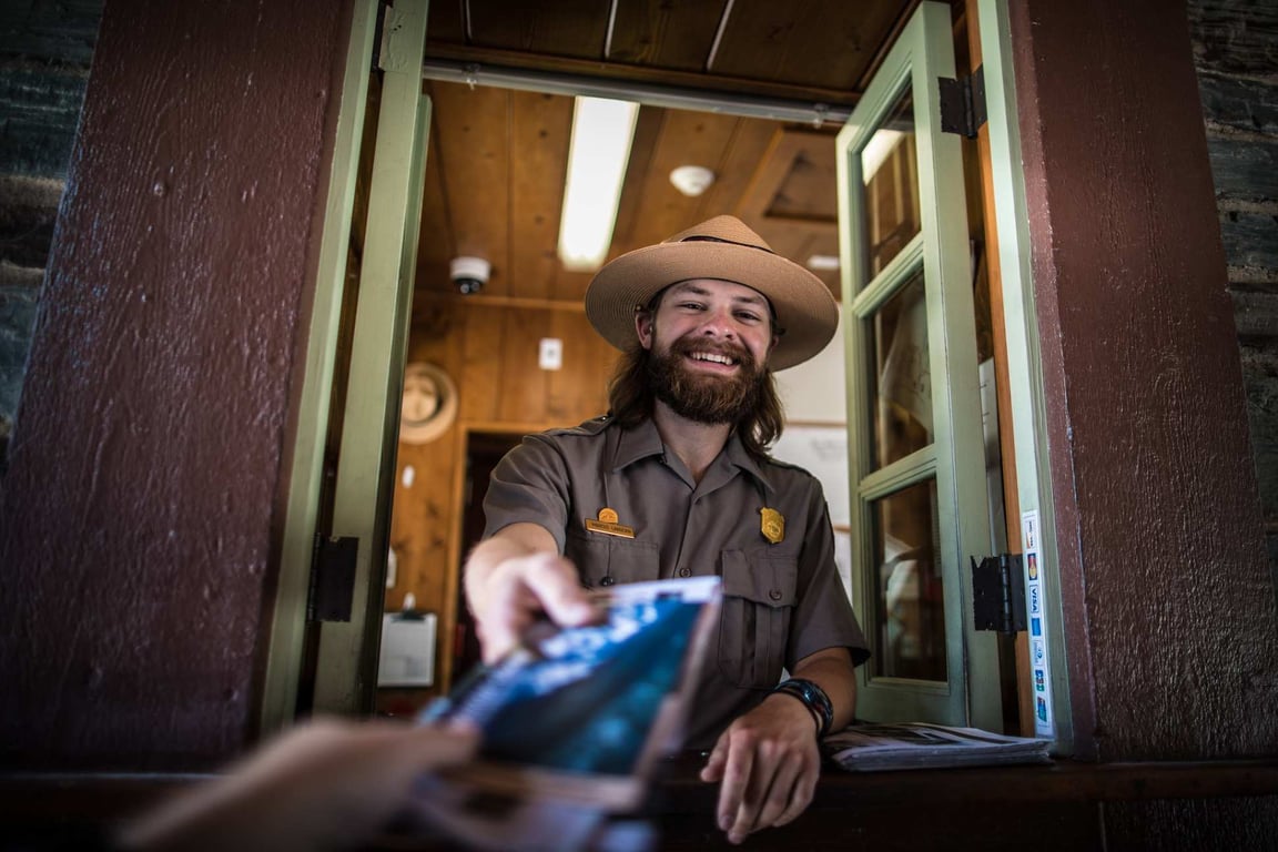 Glacier National Park ranger handing a map