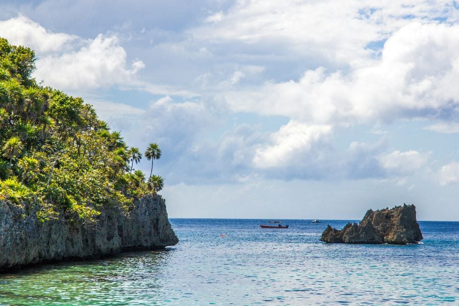 A peaceful coastline with rocky cliffs and calm ocean views.
