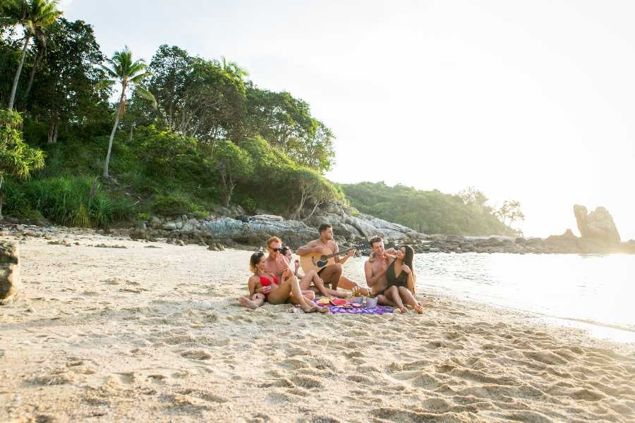 Some friends are enjoying music on the beach